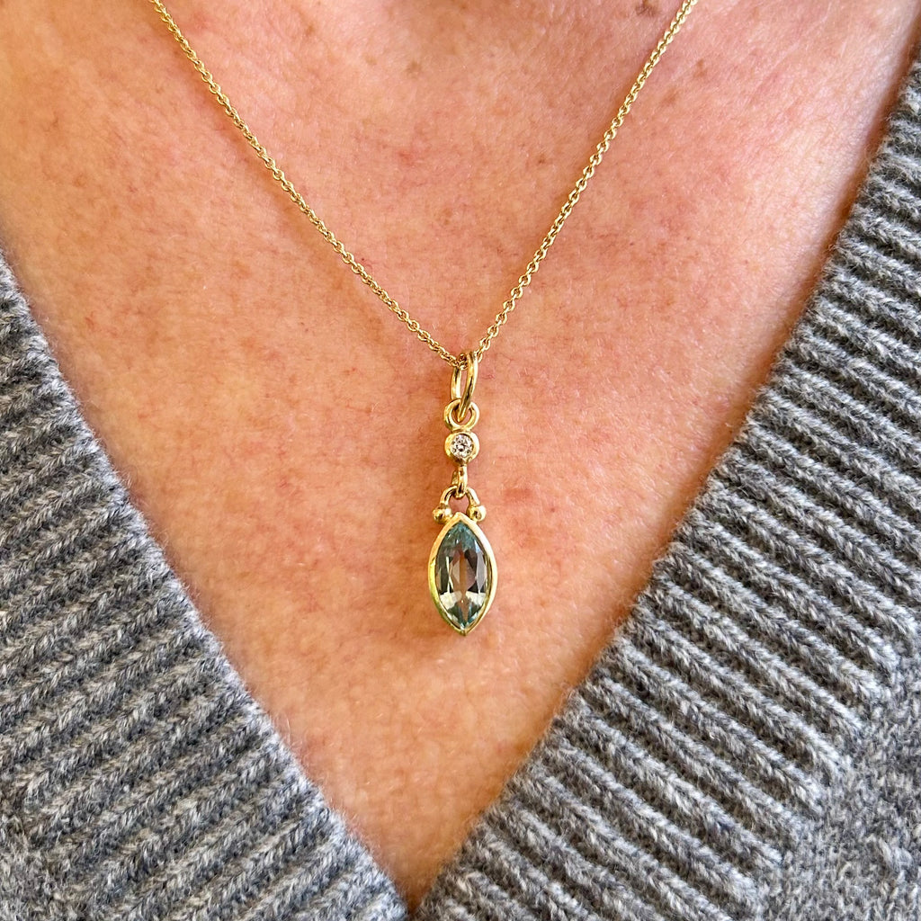 Photograph 2 of Cassie McCann's 18k Yellow Gold Aquamarine Diamond Pendant. Available on DESIGNYARD.com and in our Jewellery Shop Dublin, Ireland. Free Worldwide Shipping with DHL.