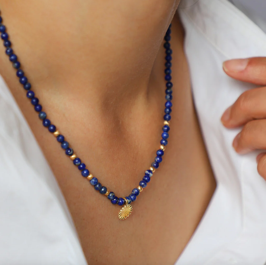 Photograph 4 of Flora Bhattachary's 18k Yellow Gold Lotus Lapis Necklace. Available on DESIGNYARD.com and in our Jewellery Shop Dublin, Ireland.