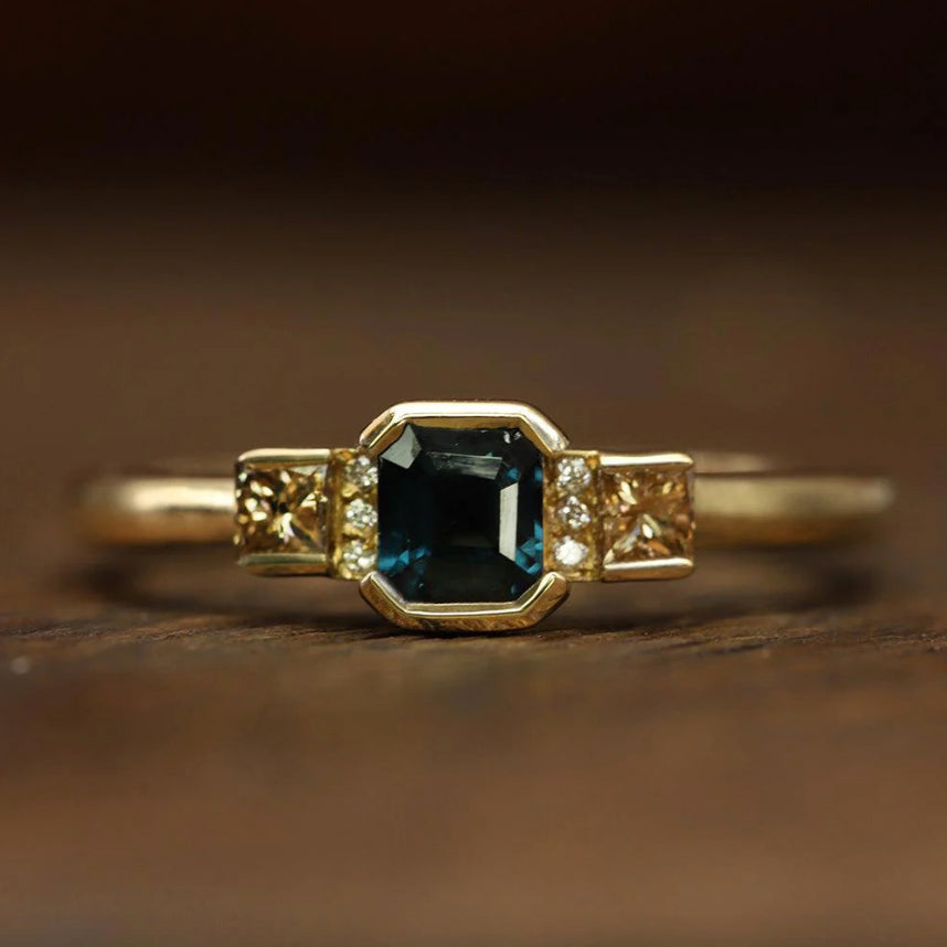 Photograph 1 of Flora Bhattachary's 18k Yellow Gold Nova Teal Sapphire Diamond Engagement Ring. Available on DESIGNYARD.com and in our Jewellery Shop Dublin, Ireland.