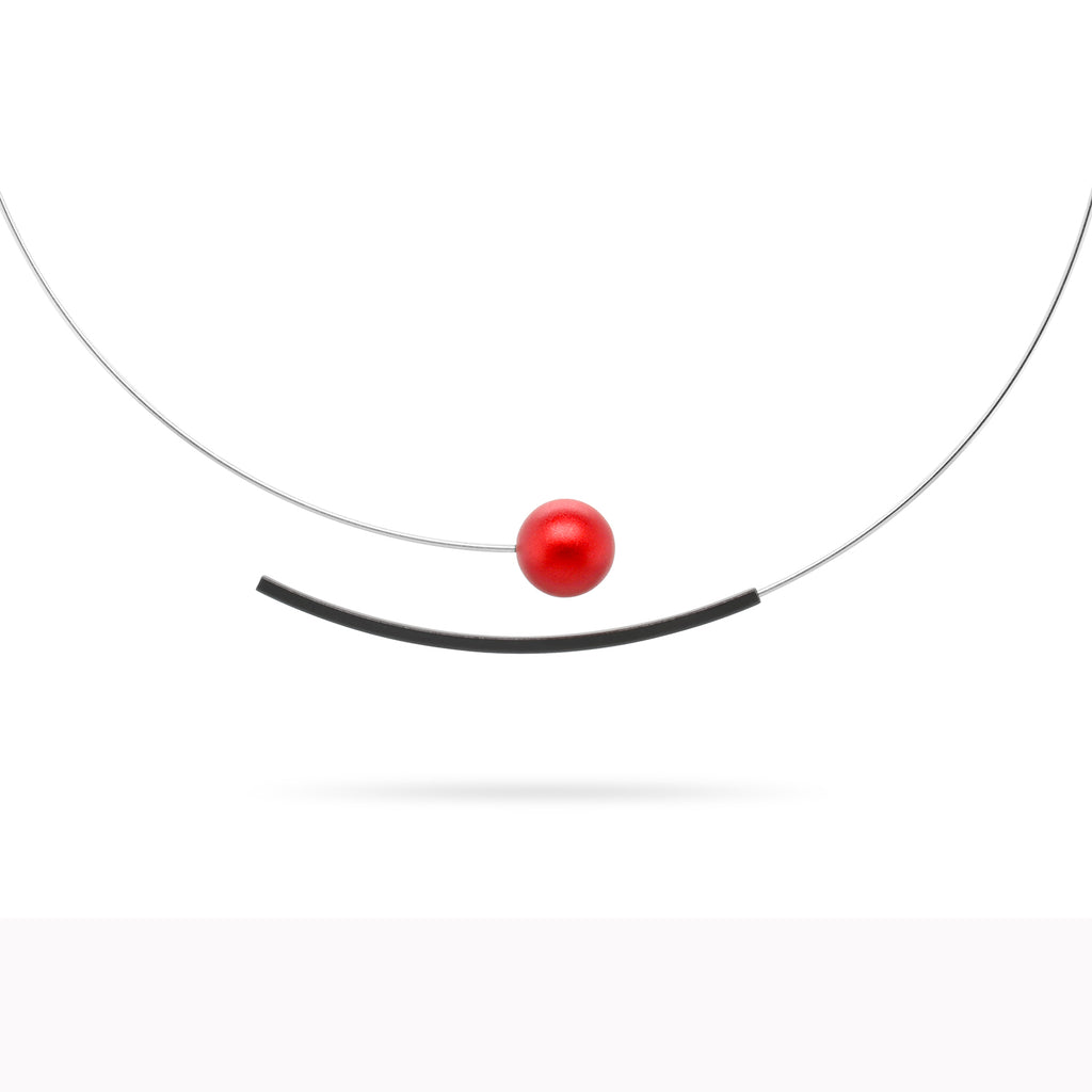 Photograph 1 of Ursula Muller's Contemporary Red Ball Aluminium Stainless Steel Statement Necklace. Available on DESIGNYARD.com and in our Jewellery Shop Dublin, Ireland. Worldwide Shipping.